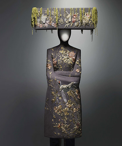 Alexander McQueen (British, 1969–2010), Ensemble, VOSS, spring/summer 2001,  Jacket of pink and gray wool bird’s-eye embroidered with silk thread; trouser of pink and gray wool bird’s-eye; hat of pink and gray wool bird’s-eye embroidered with silk thread and decorated with Amaranthus, Courtesy of The Metropolitan Museum of Art, Photograph © Sølve Sundsbø/Art + Commerce
