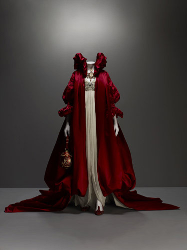 Alexander McQueen (British, 1969–2010), Ensemble, The Girl Who Lived in the Tree, autumn/winter 2008–9, Coat of red silk satin; dress of ivory silk chiffon embroidered with crystal beads, Courtesy of The Metropolitan Museum of Art, Photograph © Sølve Sundsbø/Art + Commerce