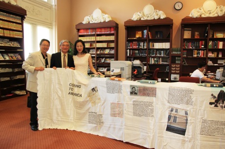 Rick Shiomi, playwright and artistic director of Mu Performing Arts, Franklin Odo, chief of the Asian Division of the Library of Congress, and artist Lia Chang display "Coming to America", Chang's Fabric Book Art Installation in the Asian Reading Room of the Library of Congress in the Thomas Jefferson Building in Washington D.C. on July 27, 2011. Photo by Reme Grefalda