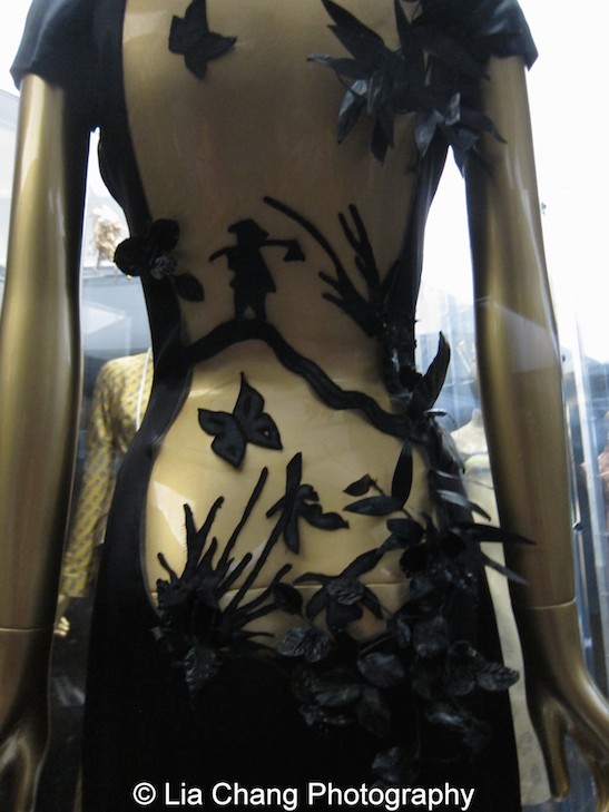 An haute couture Jean Paul Gaultier Evening dress from 2001–2 of black lacquered silk satin and nude silk tulle embroidered with black synthetic thread.