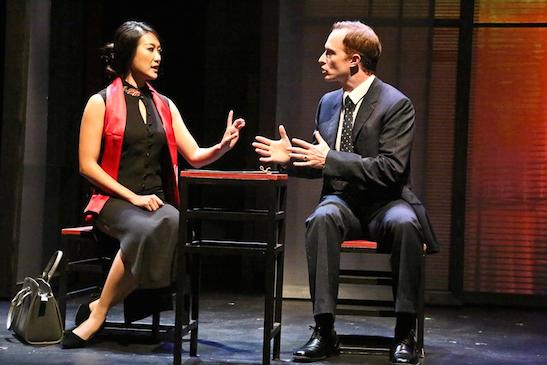 Xi Yan, vice minister of culture, played by Kara Wang, explains a situation to American businessman Daniel Cavanaugh, played by Matthew Jaeger. Photo by Michael Lamont